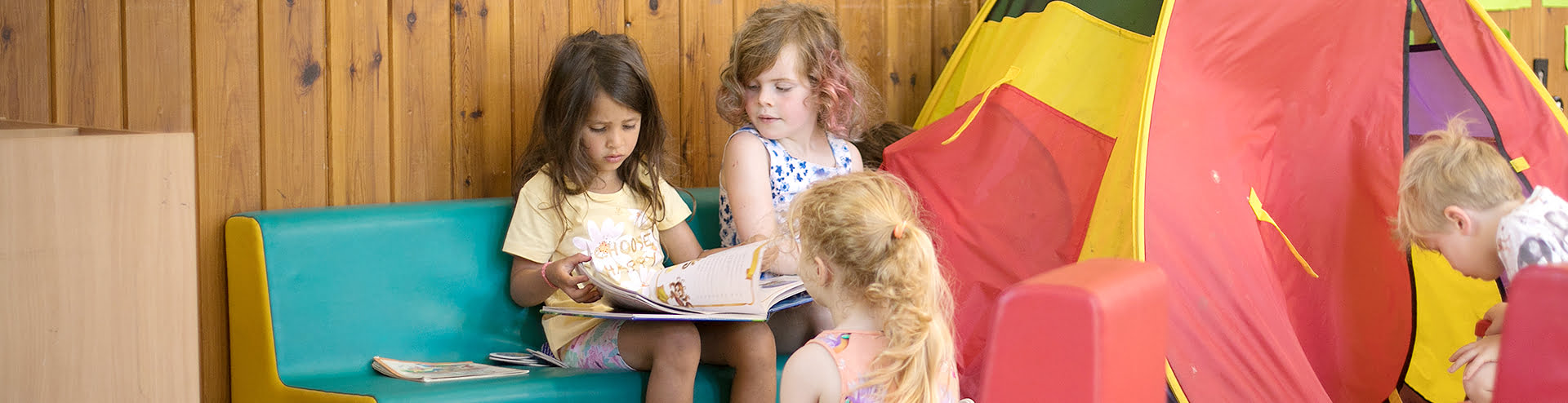 Girl reading watched by two others